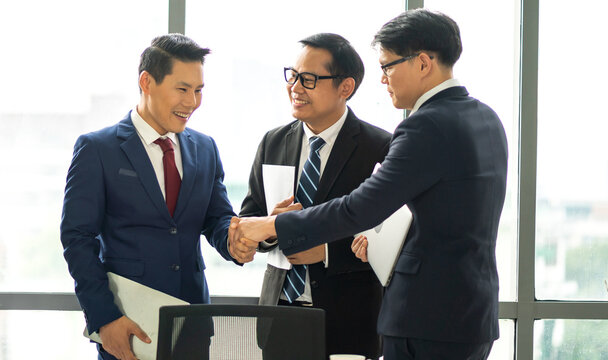 Image two business partner meeting successful handshake together with success join congratulation good deal contract in modern office.Partnership approval and teamwork concept
