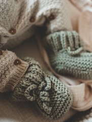 Knitted slippers and things for a newborn in the cradle