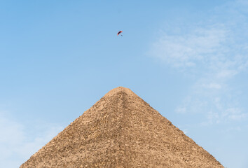 Fototapeta na wymiar Flying on a glider over the Top of the Egyptian Pyramid