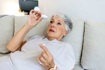 Senior woman, vision and, eye care medicine and eye drops for help with eyesight problem. Medical...
