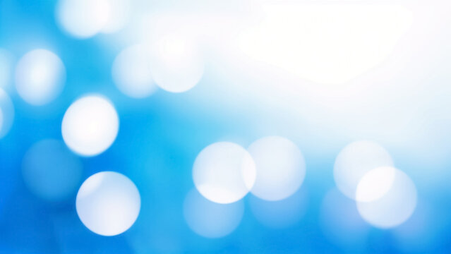 a blue and white photo of a blurry background with bokeh effects.