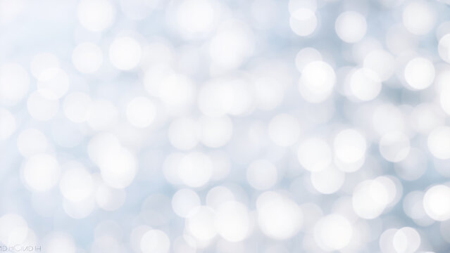 white and silver bokeh background with a hint of blue.