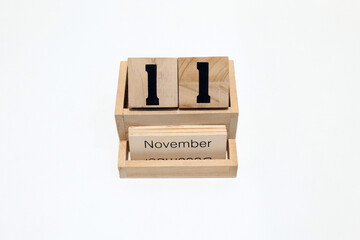 11th of November wooden perpetual calendar. Shot close up isolated on a white background