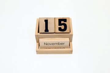 15th of November wooden perpetual calendar. Shot close up isolated on a white background