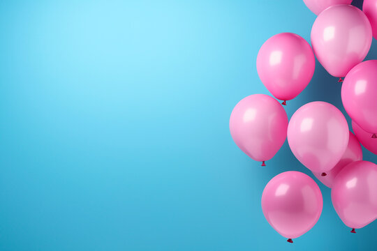 Colorful balloons isolated on a solid blue background, with space to put texts
