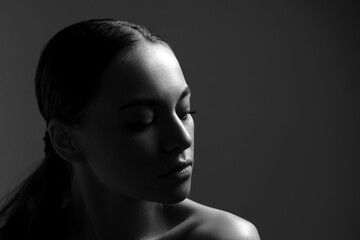 Black and white fashion art studio portrait beautiful elegant woman with bare shoulders close-up.