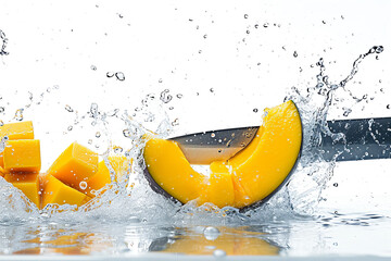 mango slices with knife and water drops and splashes on white background