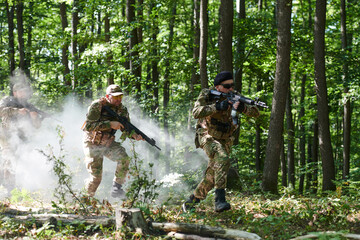 A specialized military antiterrorist unit conducts a covert operation in dense, hazardous woodland,...