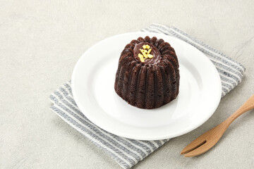Chocolate cake topped with cream cheese and melted chocolate

