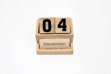 4th of December wooden perpetual calendar. Shot close up isolated on a white background 