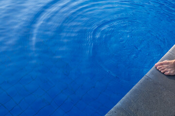Clean water in the swimming pool. Man near the pool