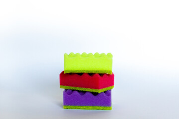 Stack of many multi-colored dish wash sponges. Household cleaning scrub pad. Home cleaning concept. Space for text