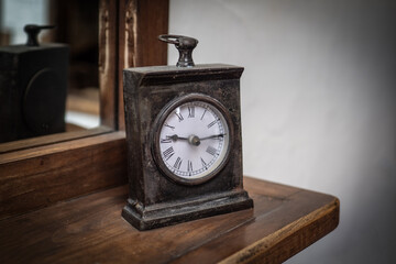 Ancient and vintage clock on table