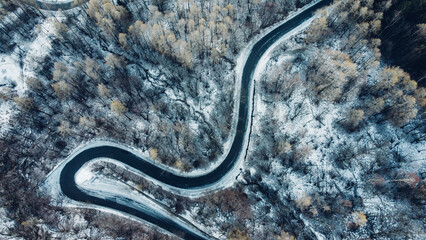 Aerial view of winding mountain road in winter.