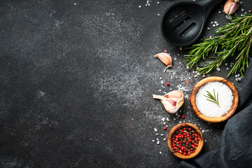 Food background. Spices and herbs at black top view with space for text.