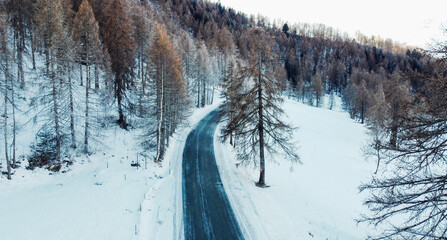 Aerial view of winding mountain road in winter. © Iryna