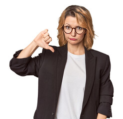Caucasian woman in black business suit showing a dislike gesture, thumbs down. Disagreement concept.