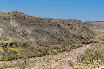 Scenic Beauty of Ait Ibourk Oasis: Palm Trees and Mountains.