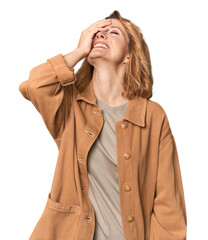 Blonde middle-aged Caucasian woman in studio laughing happy, carefree, natural emotion.