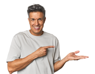 Middle-aged Latino man excited holding a copy space on palm.