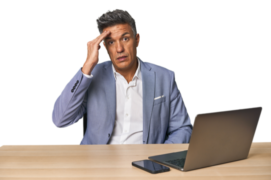 Elegant businessman at desk with laptop shouts loud, keeps eyes opened and hands tense.