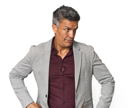 Middle-aged Latino man confused, feels doubtful and unsure.