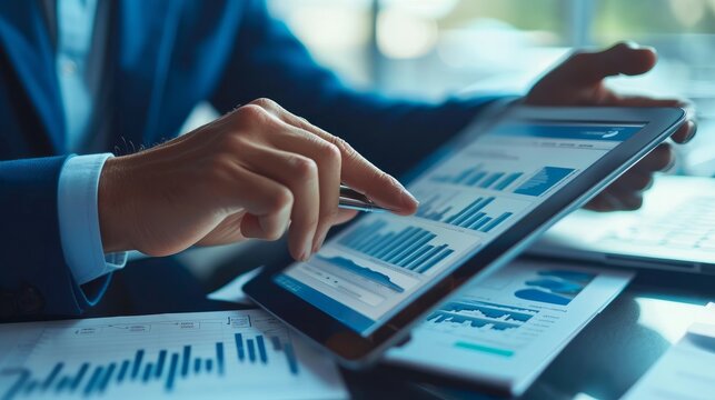 A businessman analyzing a Gantt chart on a tablet computer