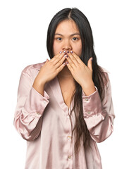 Young chinese woman isolated shocked, covering mouth with hands, anxious to discover something new.