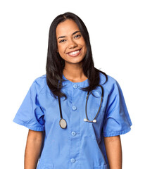 Young Filipina nurse posed in studio happy, smiling and cheerful.