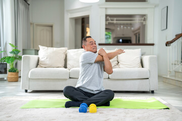 Fototapeta na wymiar Portrait of sport senior asian man training and sitting relax practicing yoga, elderly health, fitness, exercise, wellness, workout, sport at home.retirement concept.Fitness and senior healthy