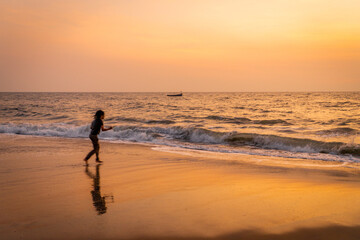 Fototapeta na wymiar People Enjoying Sunset in Alappuzha Beach (Alleppey beach) In Kerala 