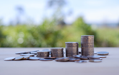 Close up stacking coins with green bokeh. money, saving and investment concept,  Save money for prepare in the future ground.