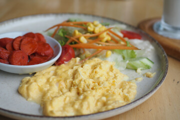 morning breakfast with Scrambled eggs on a plate 