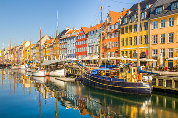 Colorful houses and boats in Nyhavn, Copenhagen’s most iconic sights for travelers. Also Hans...