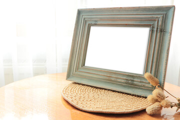 Blue color aged wood Desk photo frame. Empty horizontal picture frame mockup in minimalist interior.	