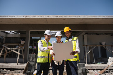 Team of professional civil engineers and architects holding project plan paper, supervising and...
