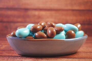  round shape chocolate candy in blue and brown color in a bowl 