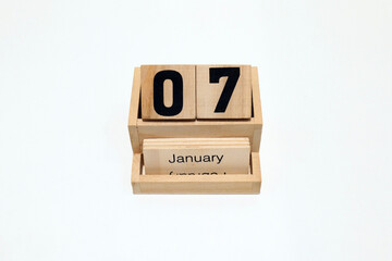 7th of January wooden perpetual calendar. Shot close up isolated on a white background 