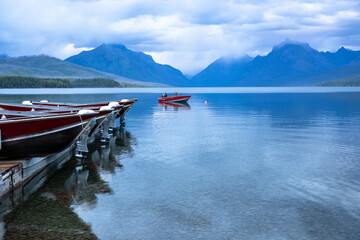 One boat left in the water while the rest are dry on the dock for the night, Apgar Village, Lake...