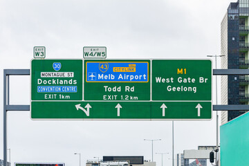 green road sign with directions to exits and citylink to Melbourne airport