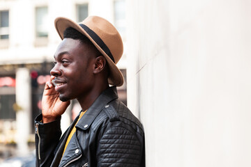 Happy black man talking on the phone and smiling