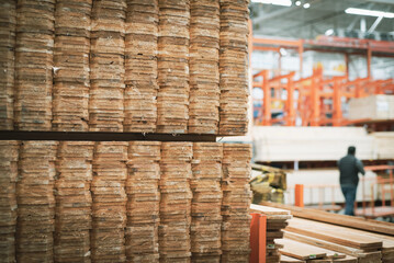 Selective focus full pallet of wooden cedar pickets with blurred customer shopping, lumber cart in background at home improvement store, Dallas, 1x6 unfinished natural look dog ear privacy top