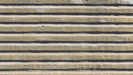 Old weathered surface with striped relief on the street