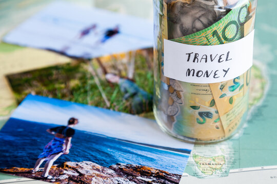 travle to coastal australian concept - photos by the sea and travel money jar