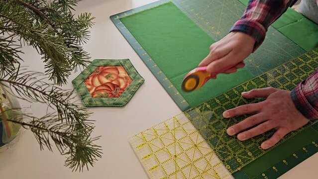 Patchwork quilt creation process - cutting of the fabric into blocks.