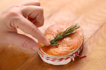 To bake a piece of salmon, add oil and a sprig of rosemary