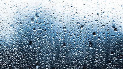 Rain drops on glass window during heavy storm.