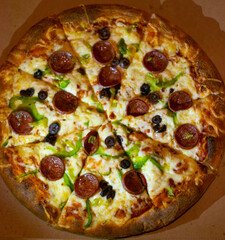 Close up shots of a delicious pepperoni pizza with Mozzarella cheese, salami, pepper, and fresh olives  Italian pizza