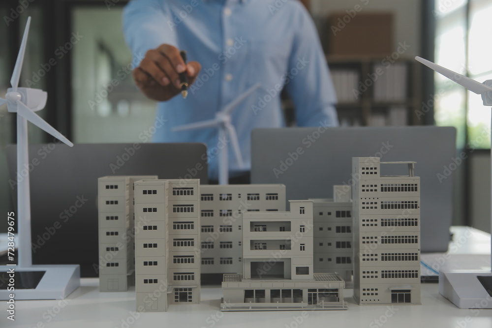 Poster Close-up at tablet, Engineers pointing at tablet with their hands. To jointly design the use of renewable energy with wind and solar energy. Concept of using renewable energy.