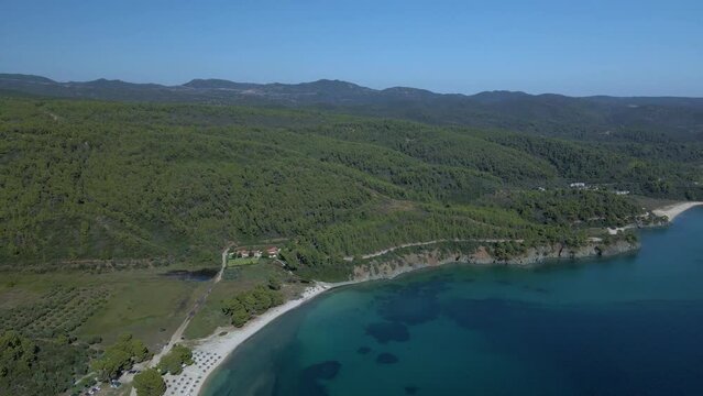 Cinematic rotating up high 4K drone clip over the tropical blue waters of Toroni in Chalkidiki